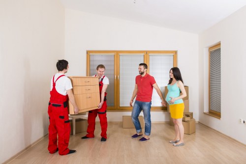 Careful loading of mixed furniture items during a local Hornsey collection